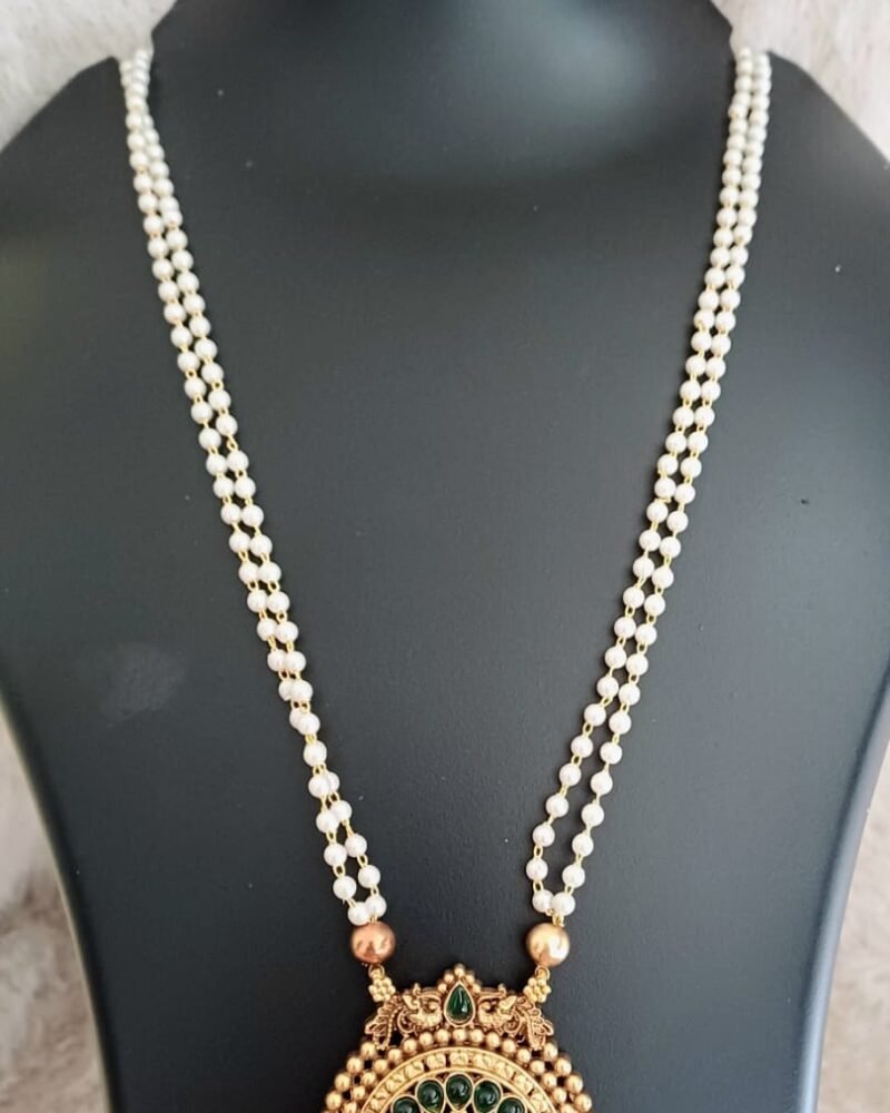 Pearl haram with green locket